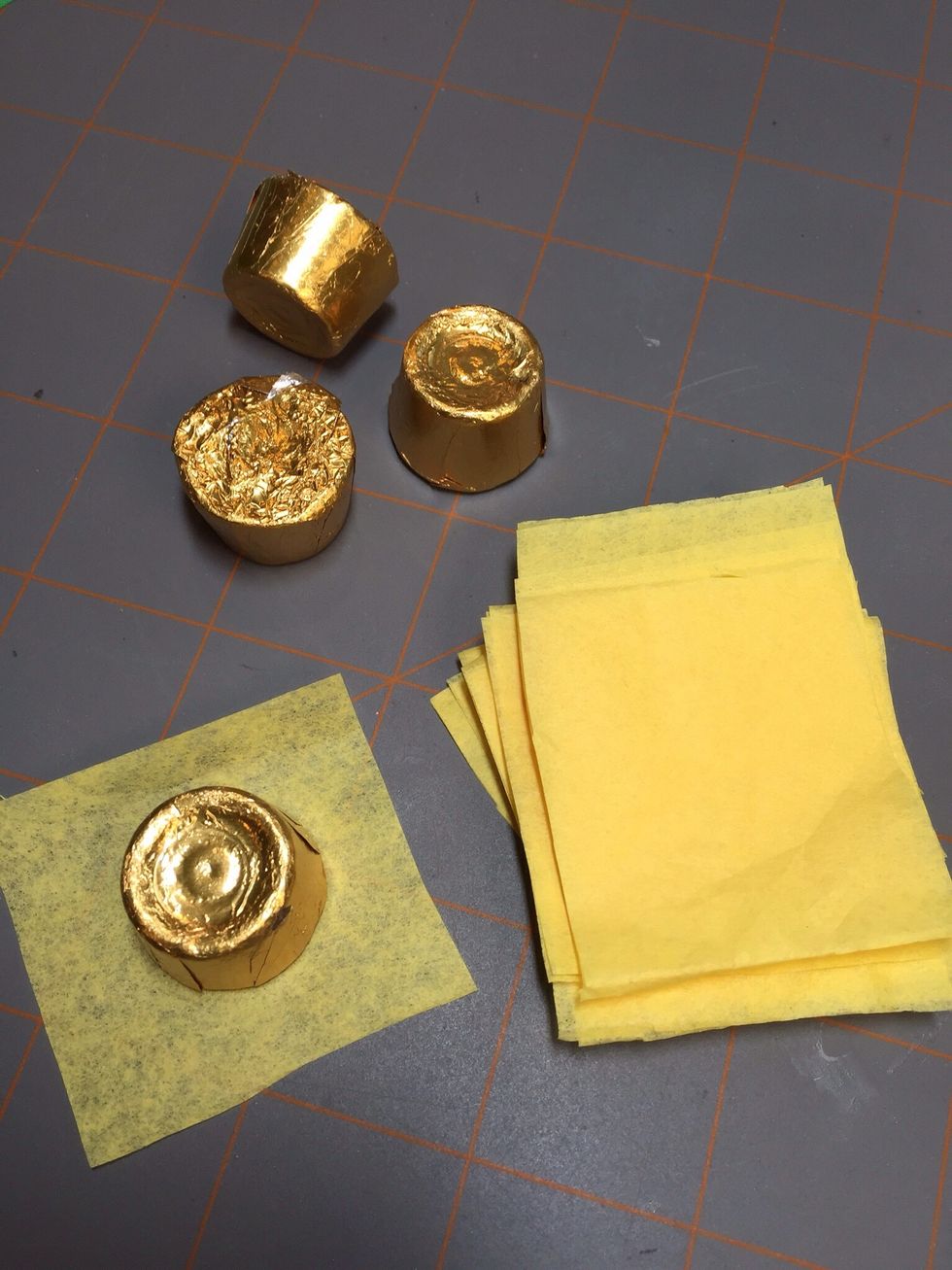 Cut tissue paper into small squares that are a bit bigger than the candy you are using.