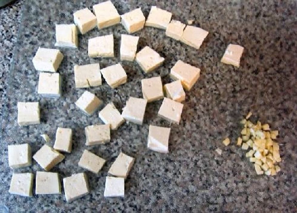 Cut tofu into small cubes and mince garlic