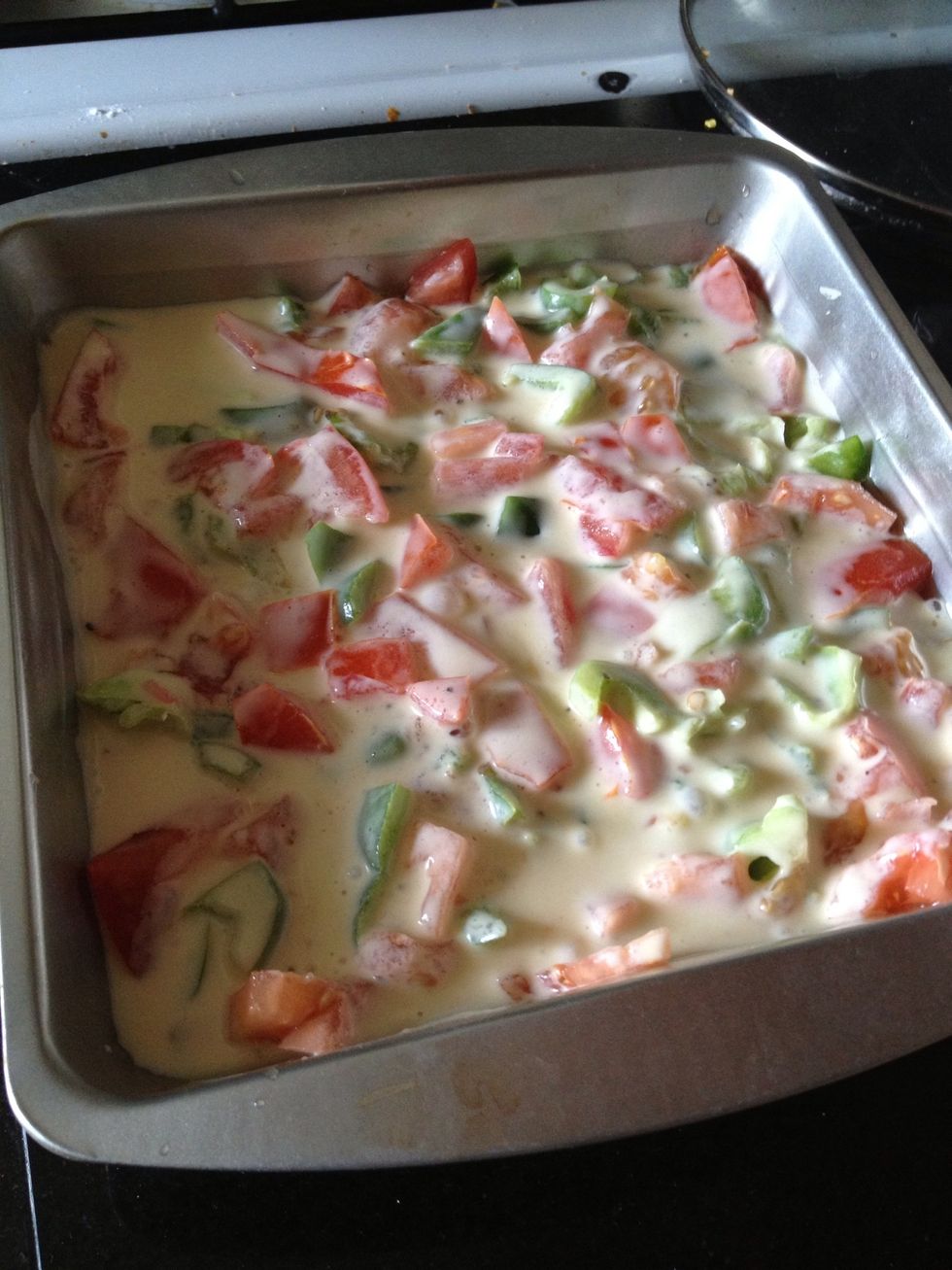 Cut tomatoes in halves and remove stem parts (if you like you omelette to be less juicy, remove seeds as well). Arrange diced tomatoes in a even layer over green pepper. Pour egg mix to the baking pan