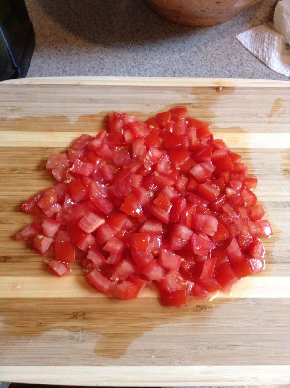 Cut tomatoes into small cubes.