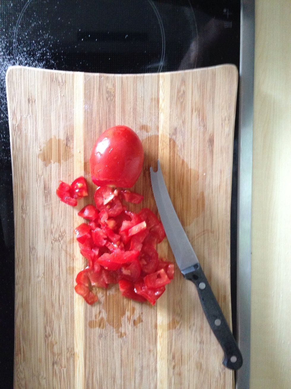 Cut tomatos into small pieces.
