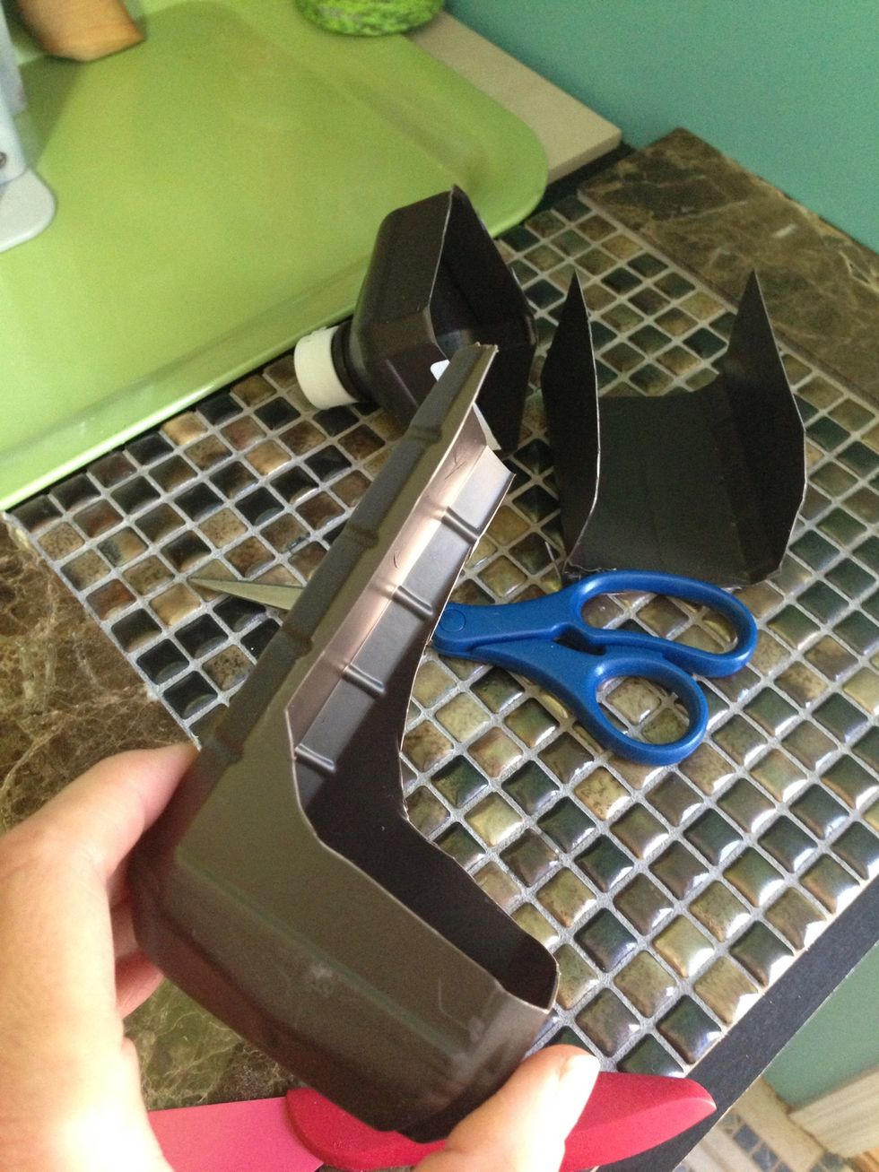 Cut top of bottle off. I used the three sided cut out piece to prop my phone in the landscape direction and it made an excellent holder to watch movies and videos with.