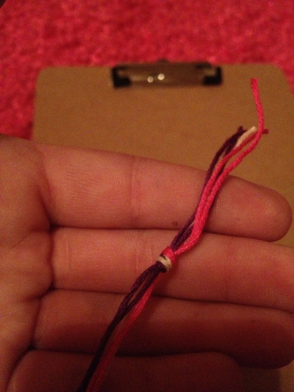 Cut two 16in strands of each color and tie them together. Make sure the two color strands are next to each other