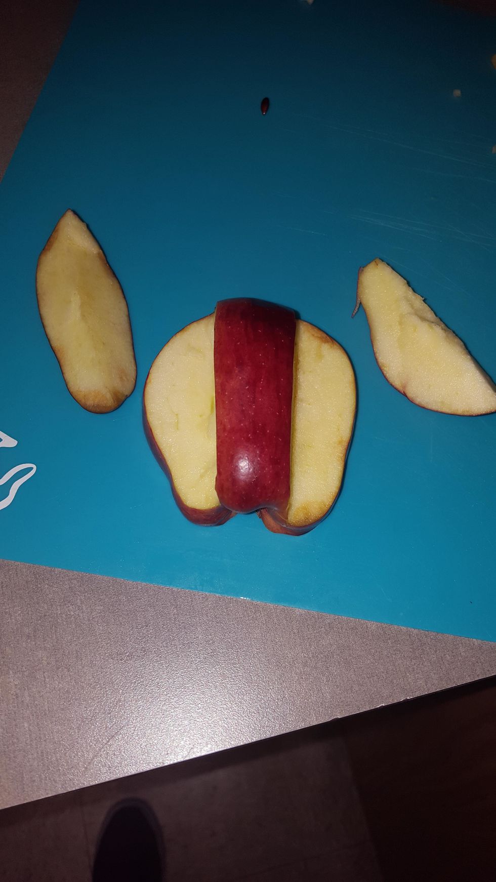 Cut two half pieces off the sides of the apple