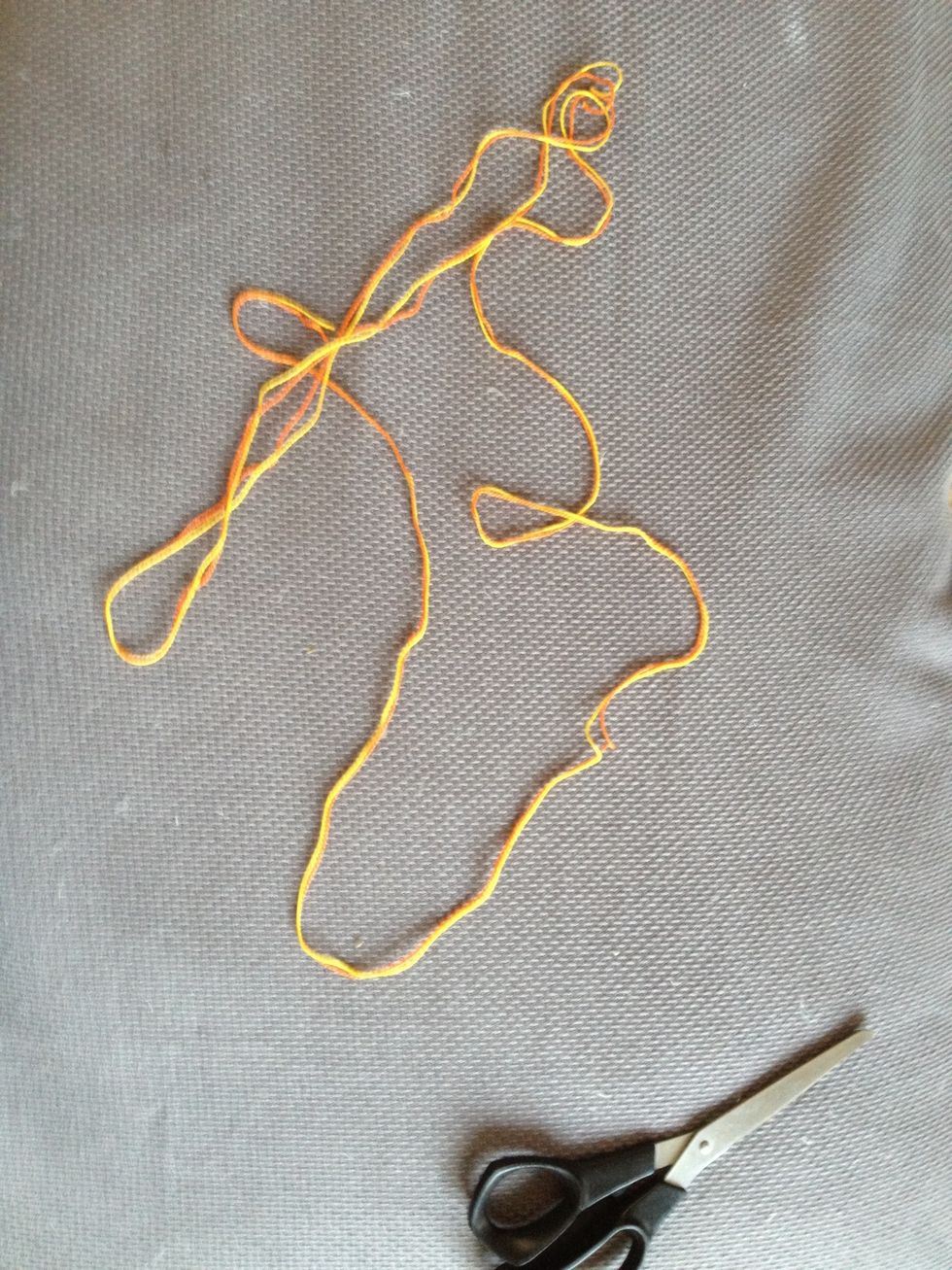 Cut two lengths of string. Only two colours needed.