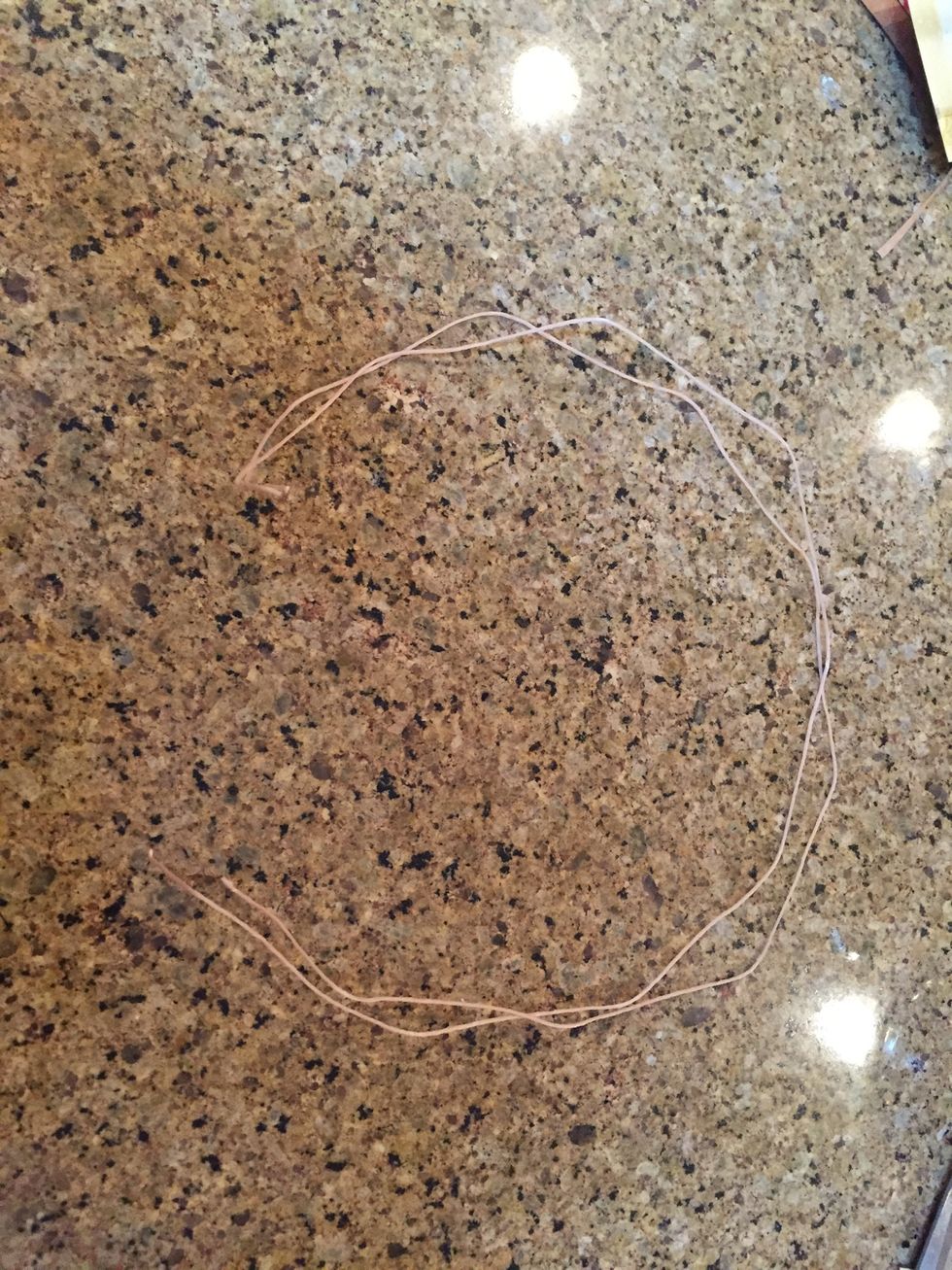 Cut two more pieces of string about a foot each