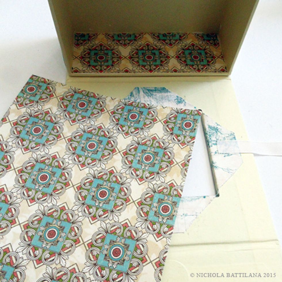 Cut two pieces of Herbal Infusion. One should fit the bottom of the box, the other the flap. Try to align the patterns. Pay attention to the orientation of the design showing through the window.