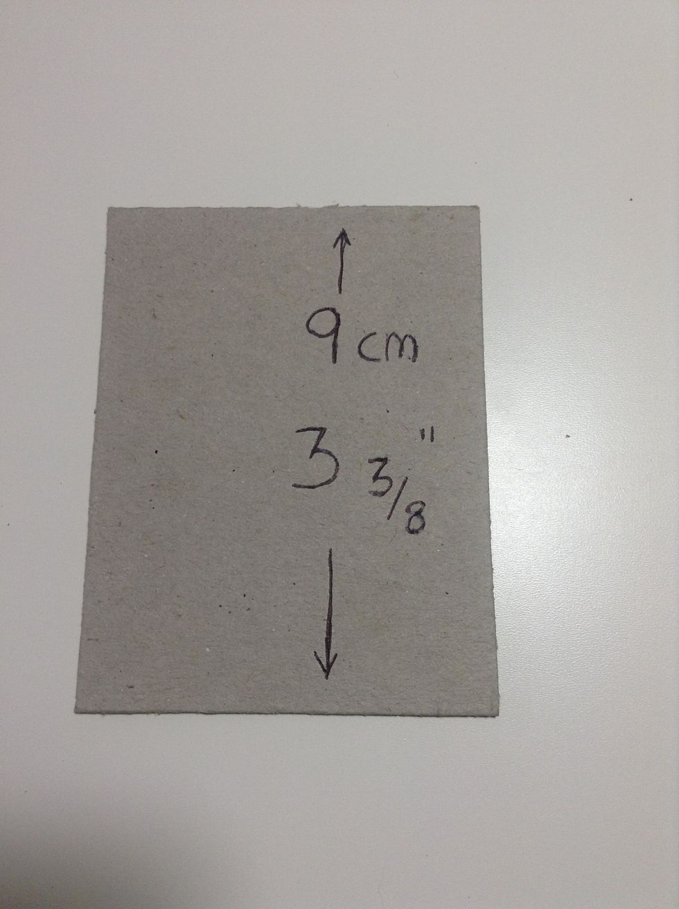 Cut two pieces of sturdy mat or chipboard: at 3 3/8\u00b4\u00b4(9cm )