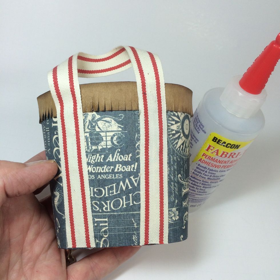 Cut two ribbons approximately 10 inches long. Use fabric glue to adhere to each side of tote.