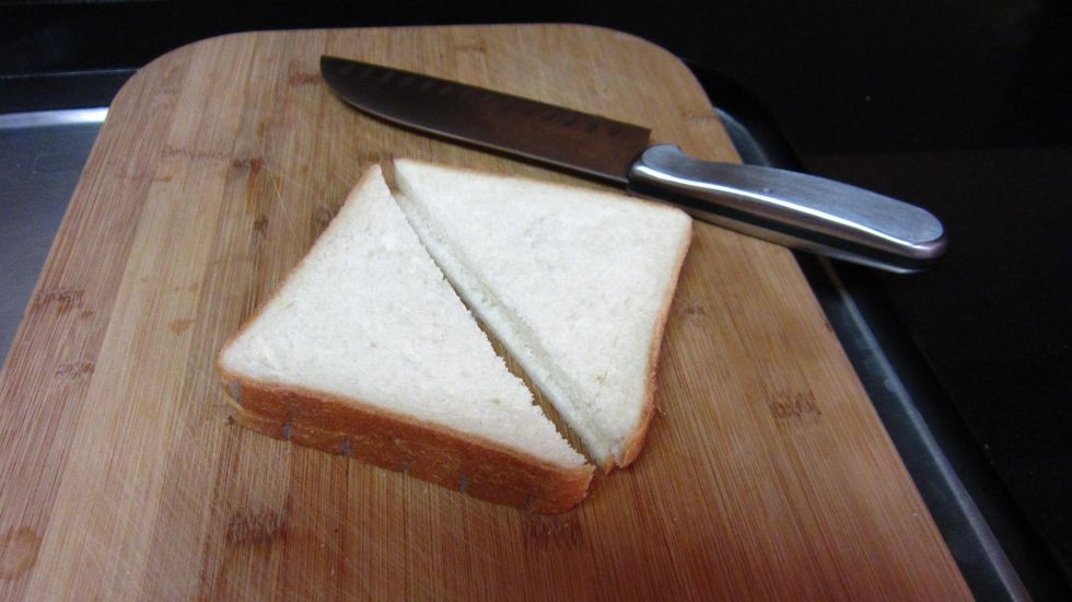 Cut two slices of bread of bread diaginally.White bread looks better and tastes better even if it is not always the best for your health.  Old bread is better as it absorbs the egg and milk better.