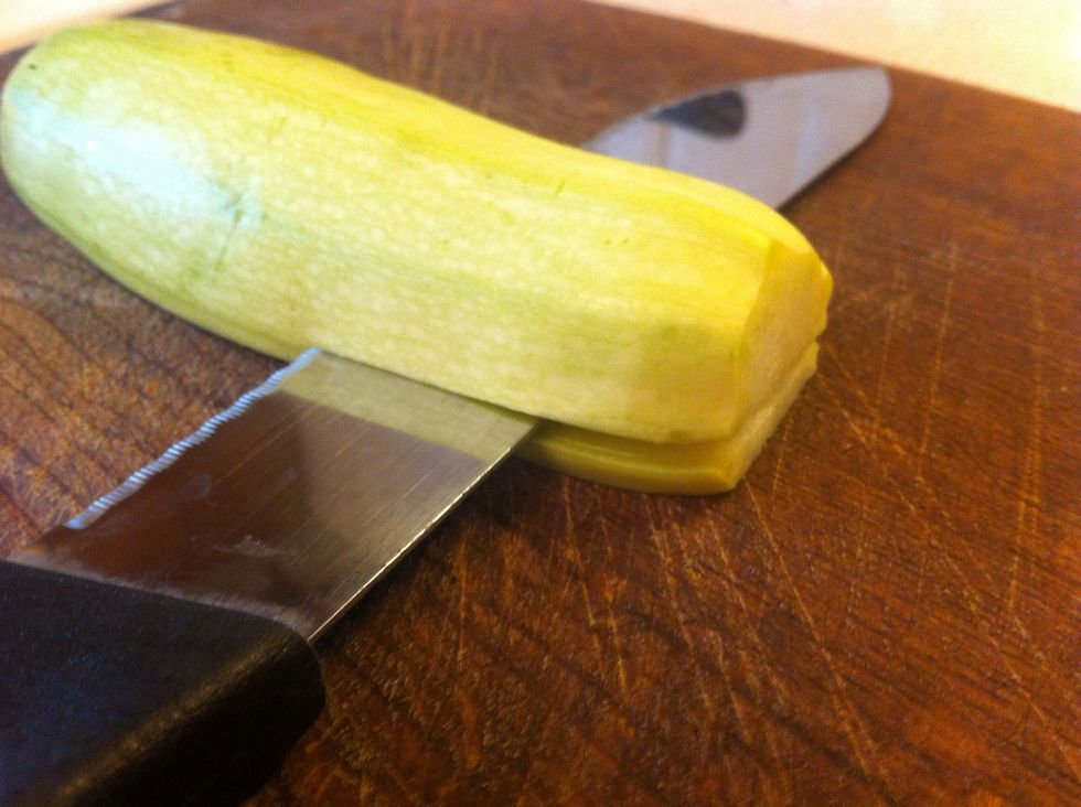 Cut two slices of vegetable marrow. Cut the tomatoes in half. Cut the cheese into small prices.