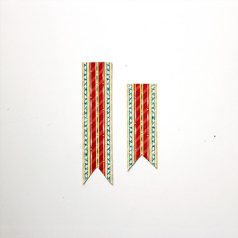 Cut two strips from the "Good Cheer" sheet.  One of the strips should be one inch longer than the other.  Cut a "V" shape at the bottom of each.