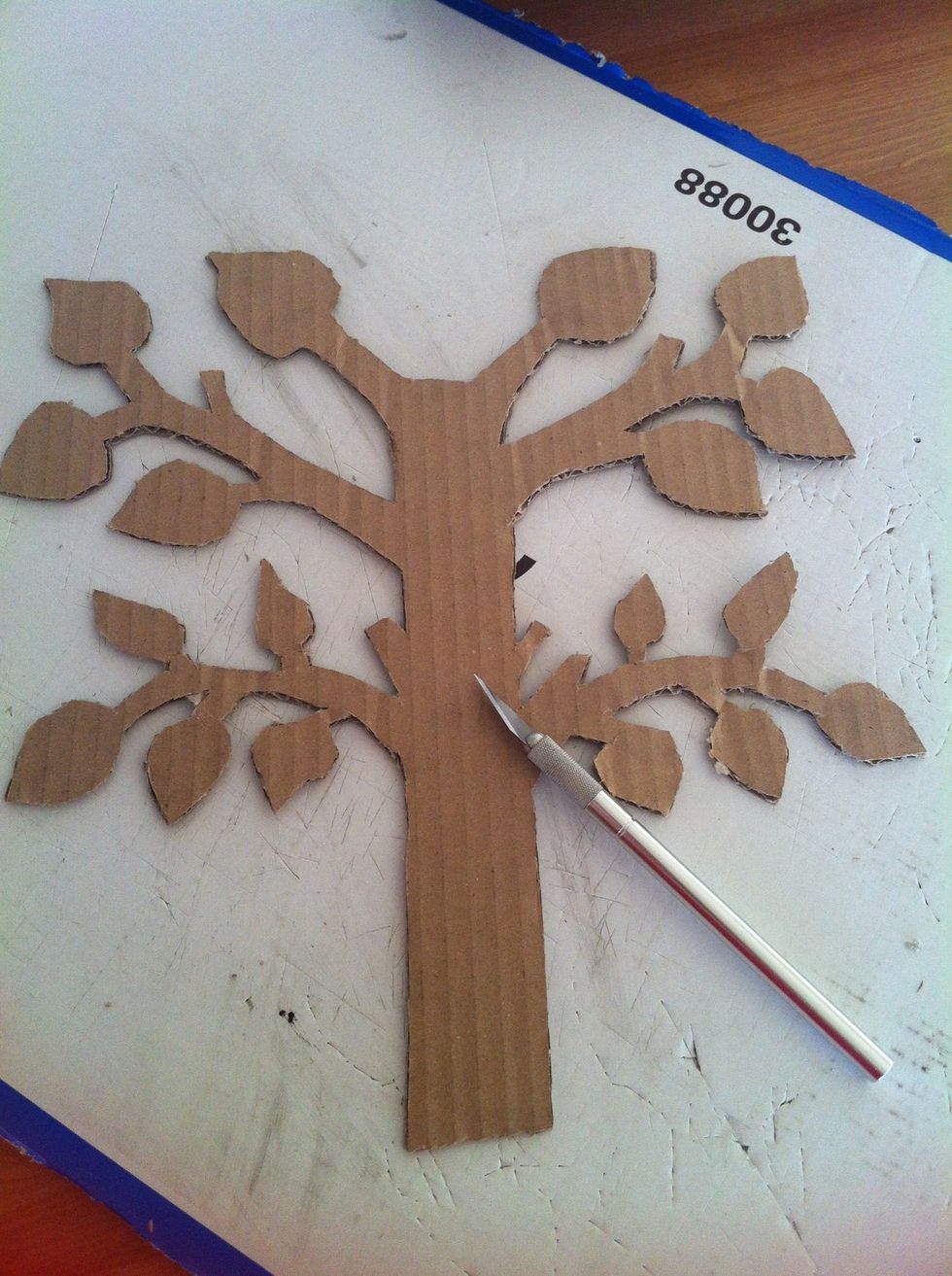Cut two trees from the cardboard. You can also use only one if you want to. Make sure one is a bit longer than the other. About 2 cm (1in).