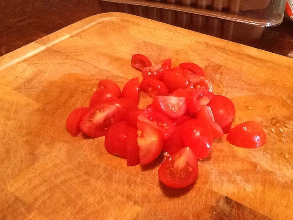 Cut up 8 cherry tomatoes into quarters.