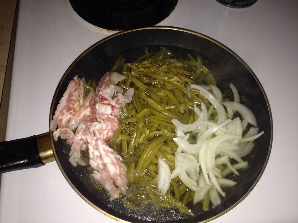 Cut up bacon then add to pan. Add pepper and chicken flavor. Cook until most of the juice (water) from the green bean evaporate!