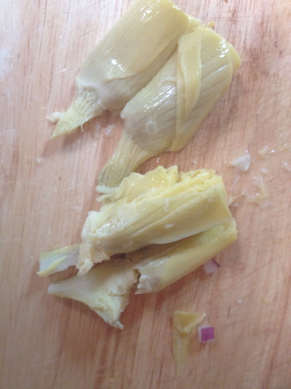 Cut up canned in water artichoke hearts. Cut in half then cut in half again. Cut vertically into smaller pieces.