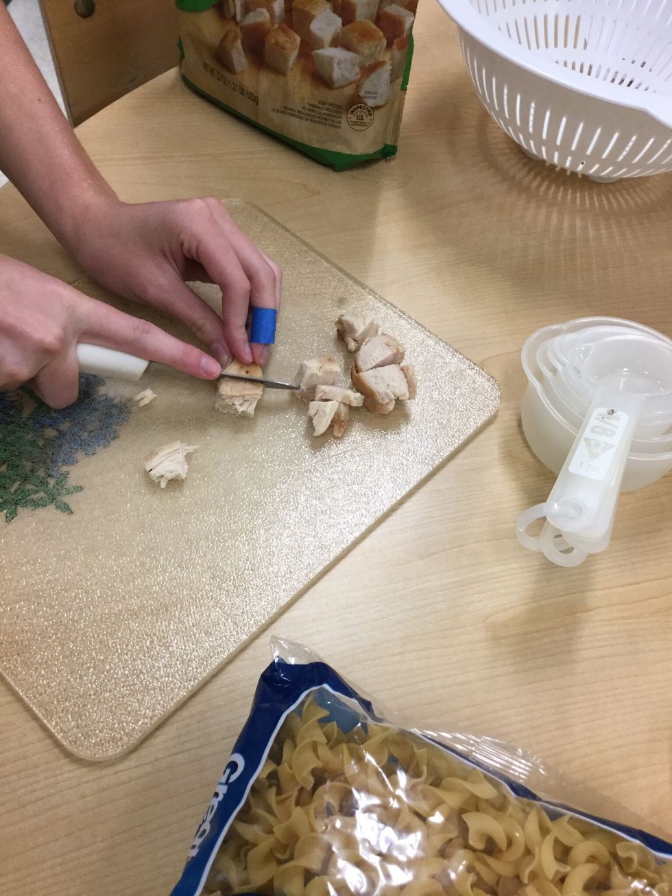 Cut up cooked chicken.