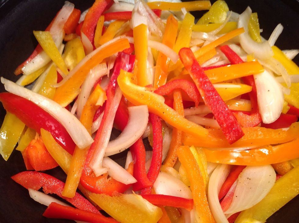 Cut up peppers and onion.  Put in a large warm skillet on medium heat.  Add some ground black pepper.