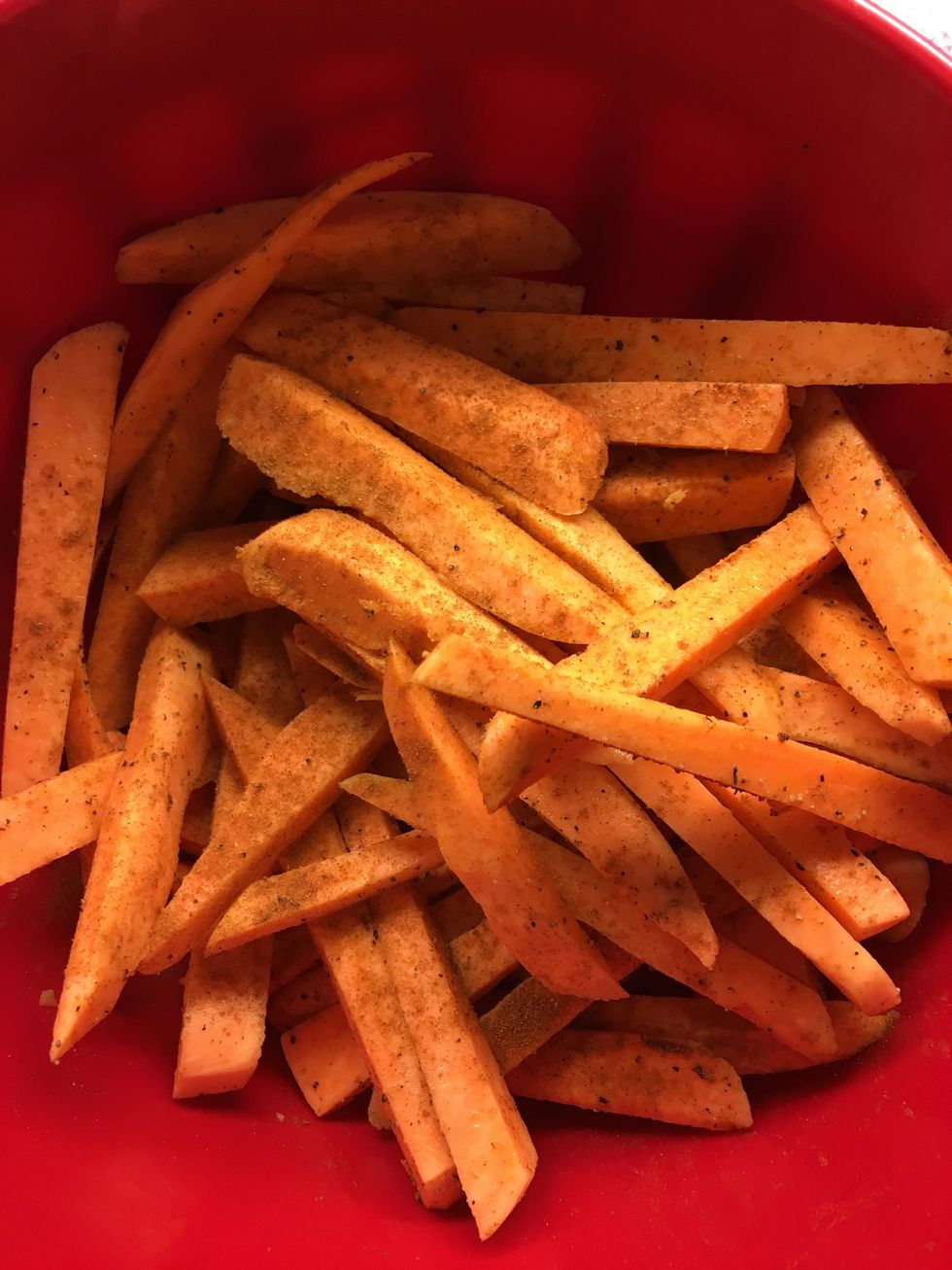 Cut up potatoes and add the salt, pepper, paprika, and olive oil.