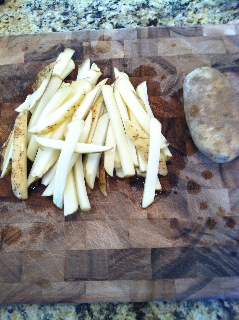 Cut up potatoes into fry shape