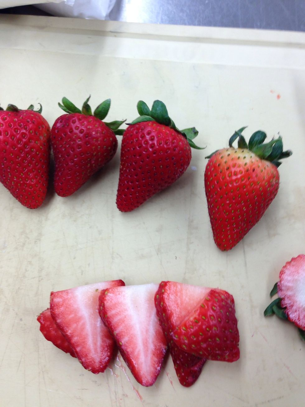Cut up sliced strawberries.