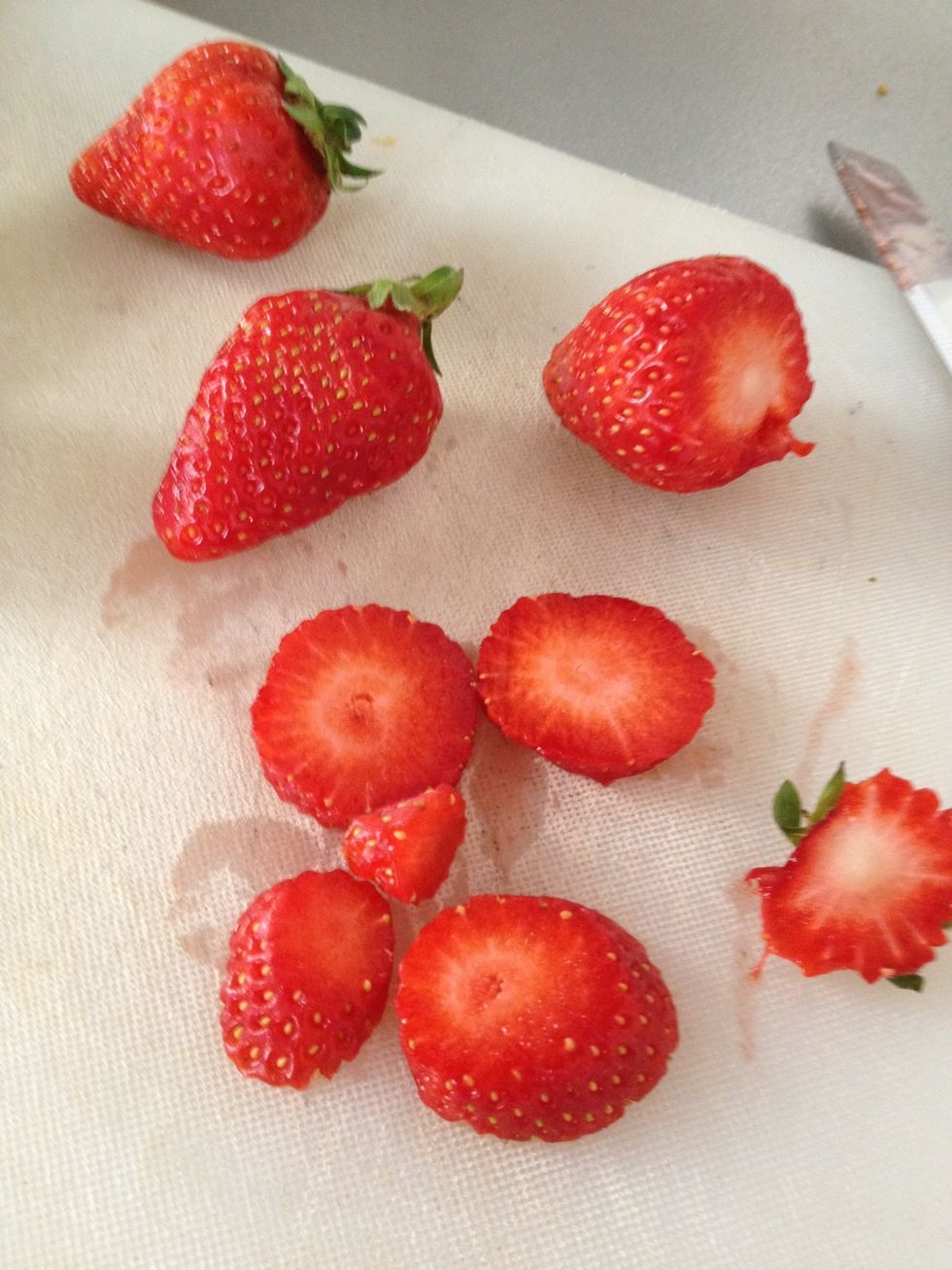 Cut up strawberries, it makes it easer and faster to blend