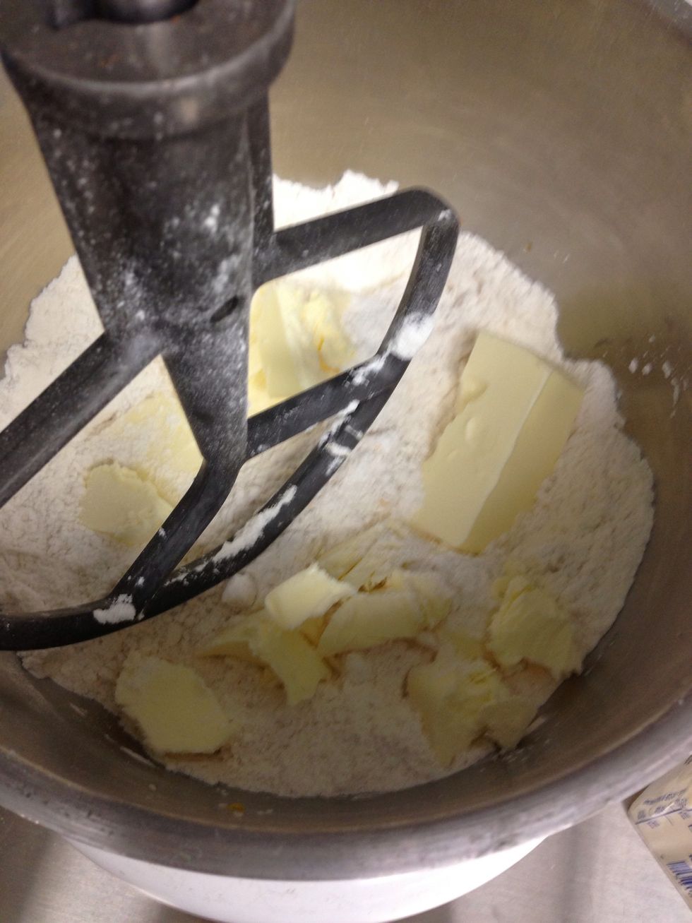 Cut up the cold butter and add it to the flour mixture mixing on low speed until incorporated.