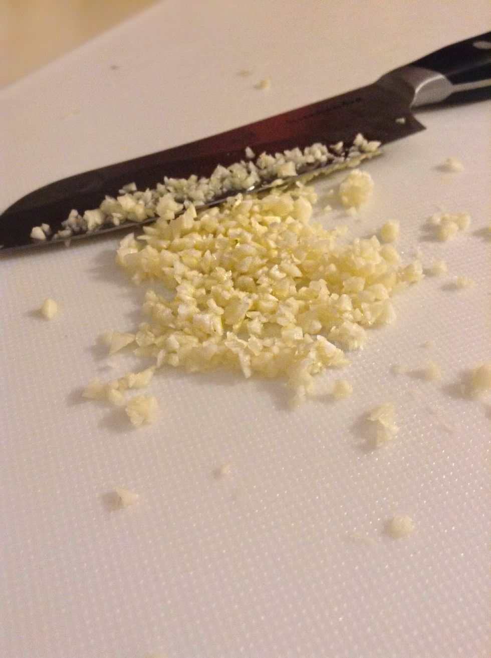 Cut up your garlic, you can use a garlic press if you have one but mine happen to go missing so I'm doing it the good old fashion way.
