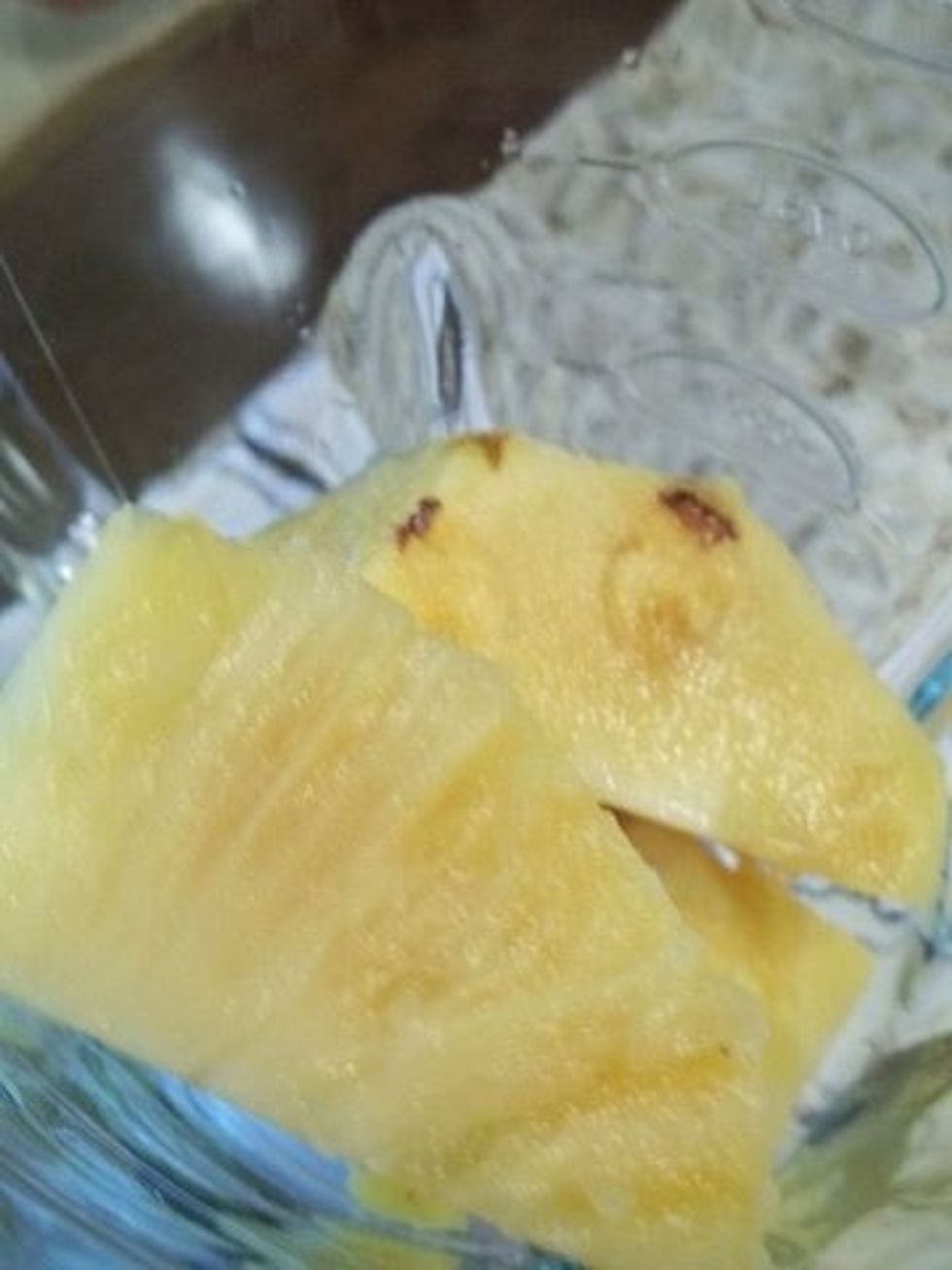 Cut up your pineapple now, I use half the pineapple and cut it up into nice little pieces and then the other half I mix in the blender and make fresh pineapple juice.