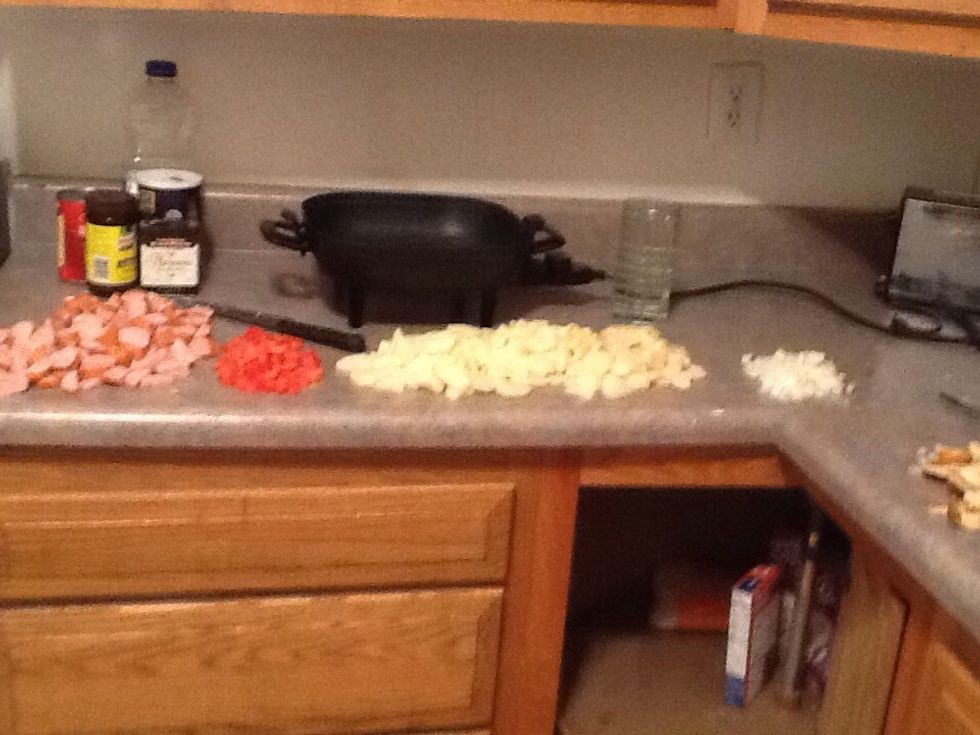 Cut up your smoke sausage, potatoes, onions, and tomatoes