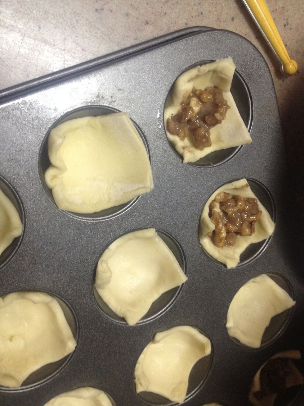 Cut ur puff pastries to suit ur cupcake tray - dont forget to spray the tray first