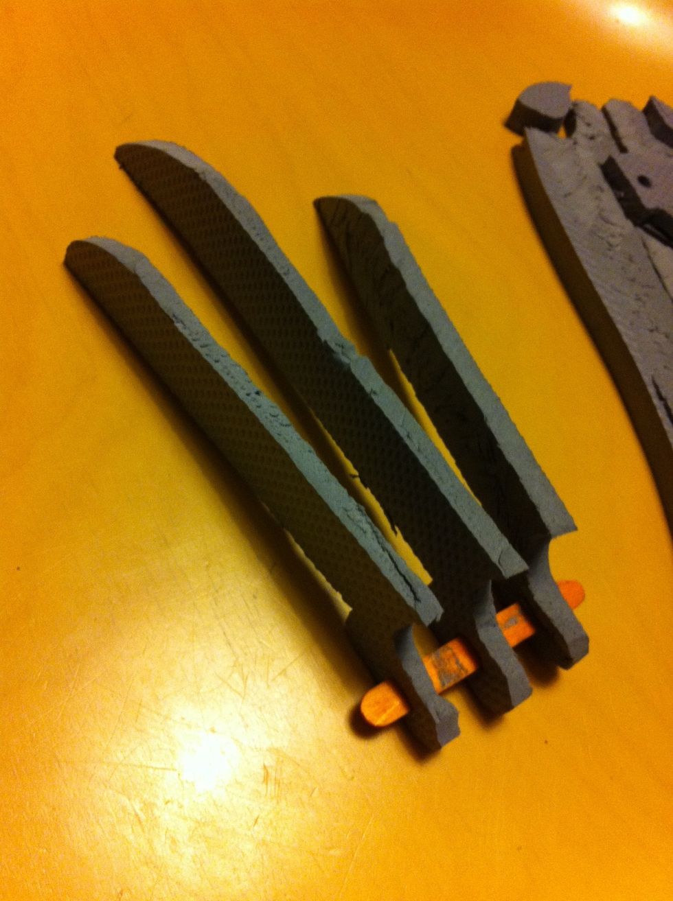 Cut very small slits in the base of each claw with the knife, and insert a short section of Popsicle stick.