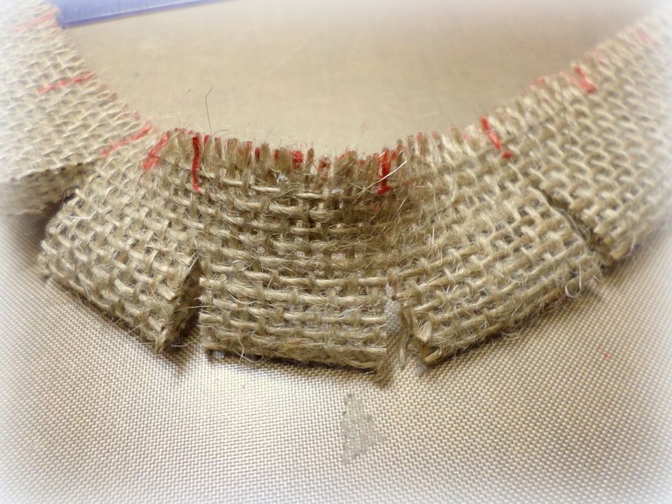 Cut where you marked but leave a small area at the top uncut. It will look like this. Don't worry about the marks you made. You will glue that side to the tree.