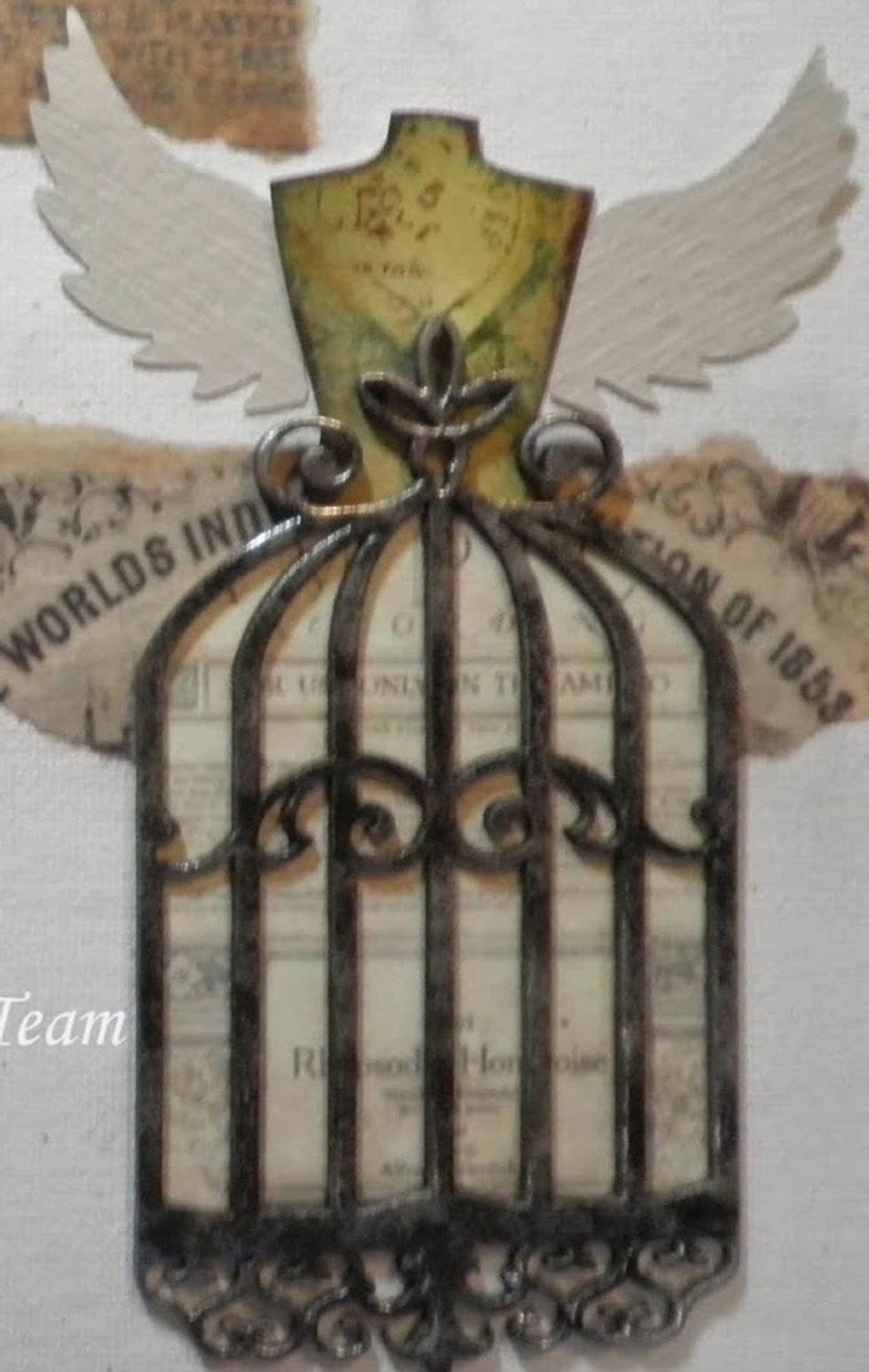 Cut wings from scrap card stock using Tim Holtz Heart Wings die. Add gold Gilder's Paste to die cut wings, and a very light coat of silver Gilder's Paste over that. These will be adhered later.