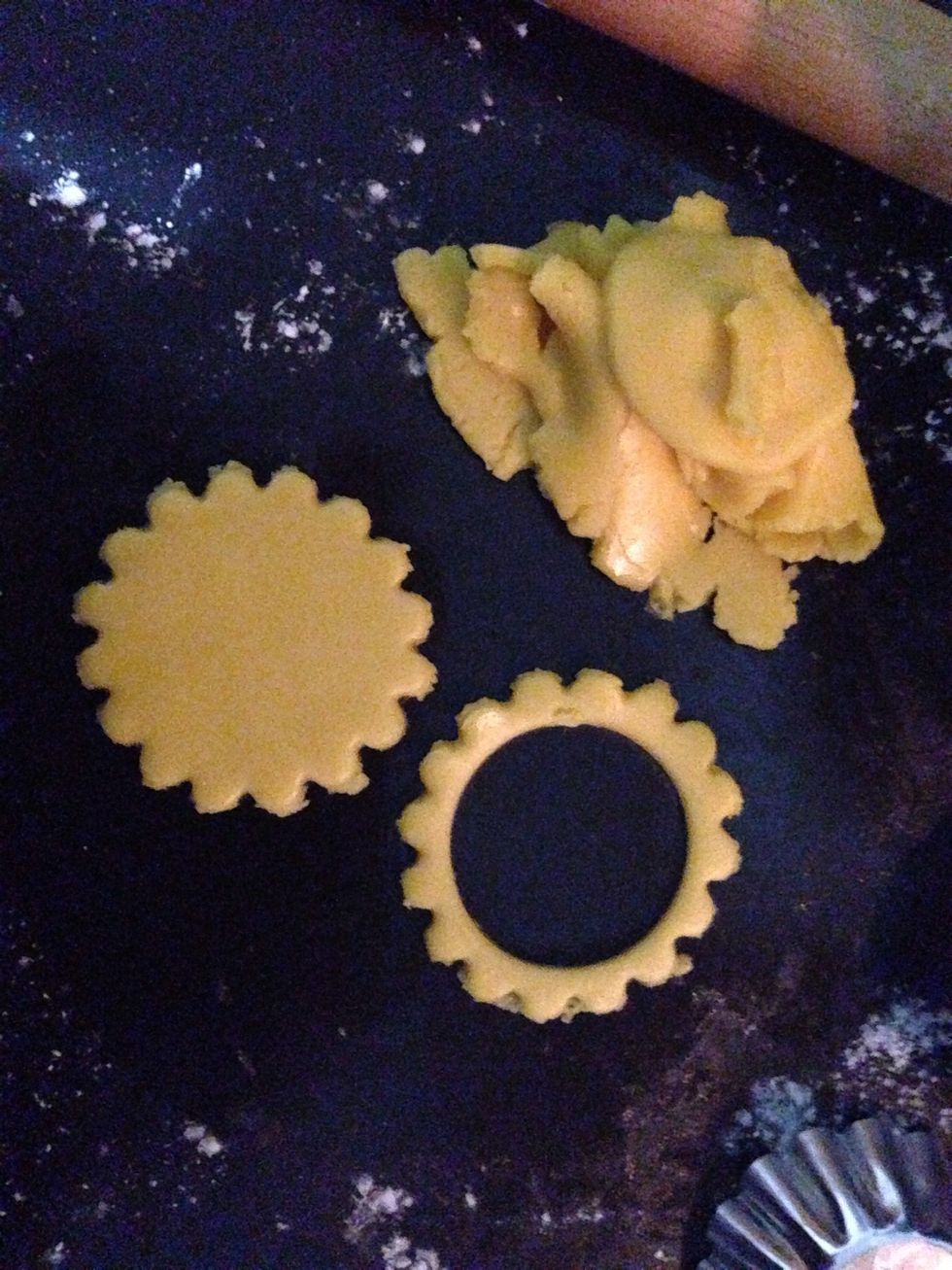 Cut with any cutter that you want and don't forget to cut out a hole at the center.Coat it with egg wash before baking.