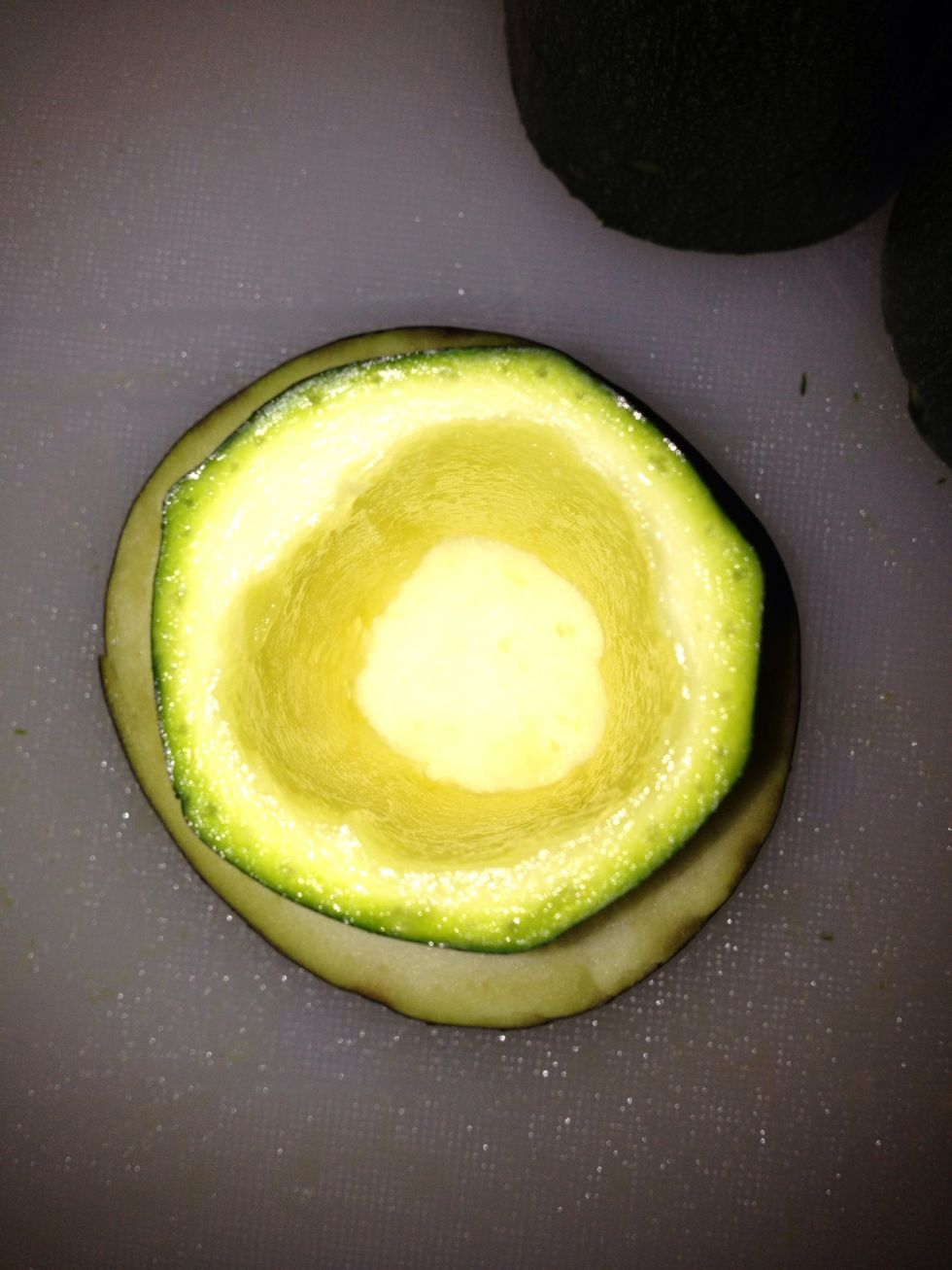 Cut you eggplant 1 cm thick place it under you zucchini and you the potato peeler to cut out a plug