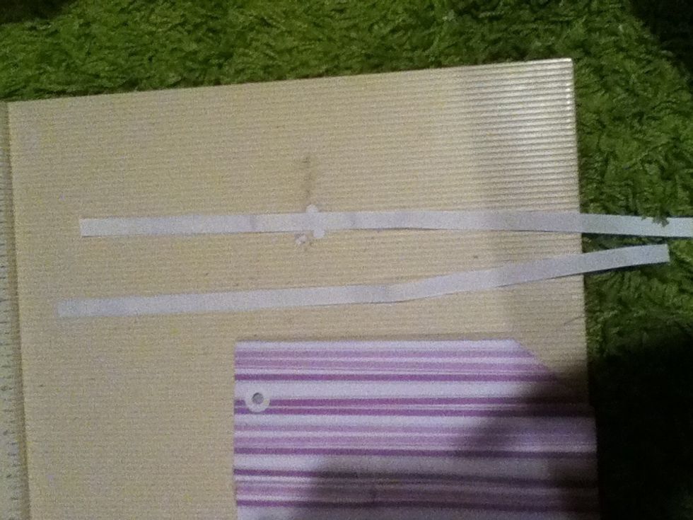 Cut you two feet of ribbon into two one- foot pieces.