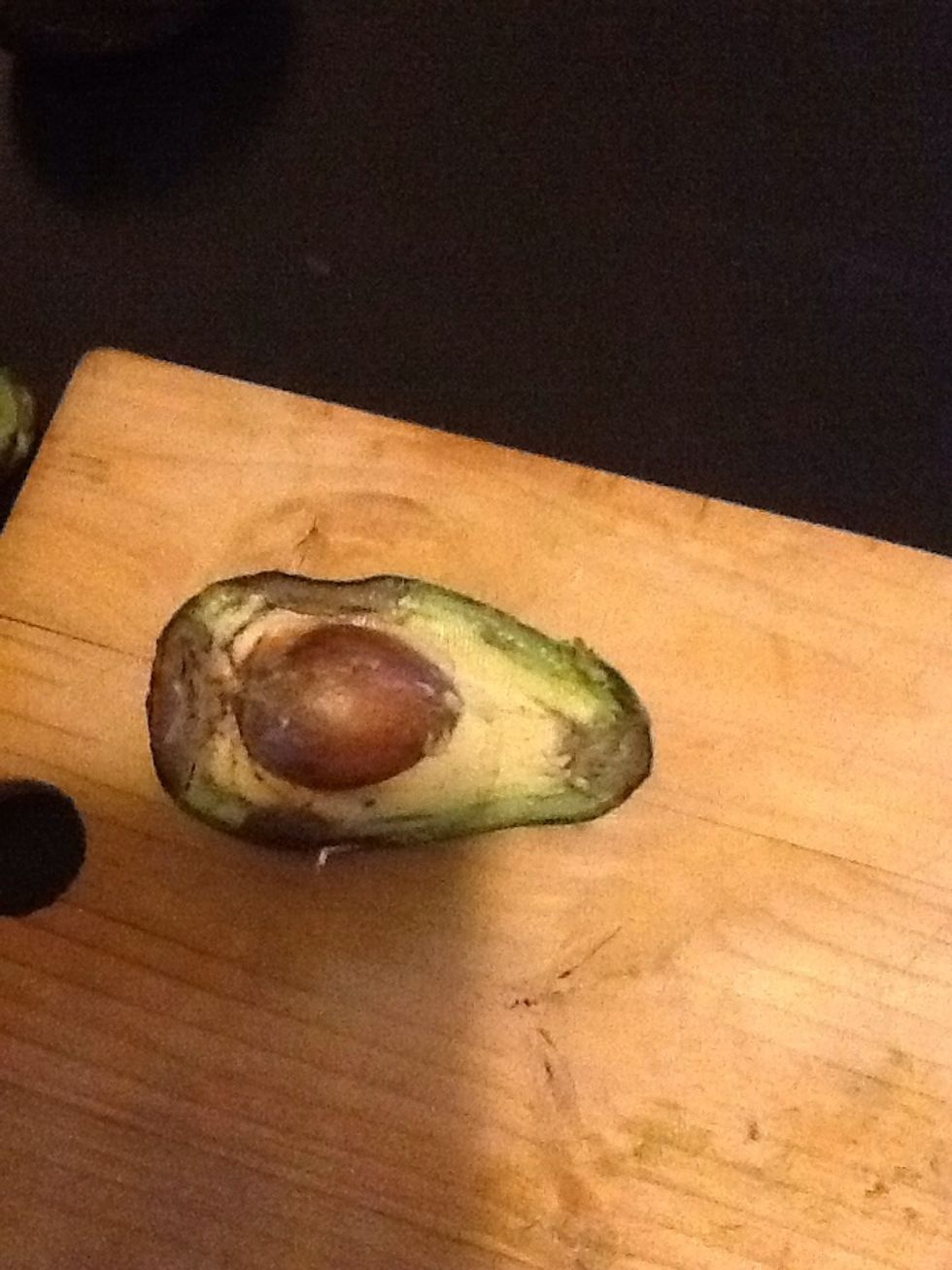 Cut your avocado in half and remove the seed and skin. Its okay if your avocado is overripe like mine, it just means more nutrients for your hair. Chop the avocado into small pieces.