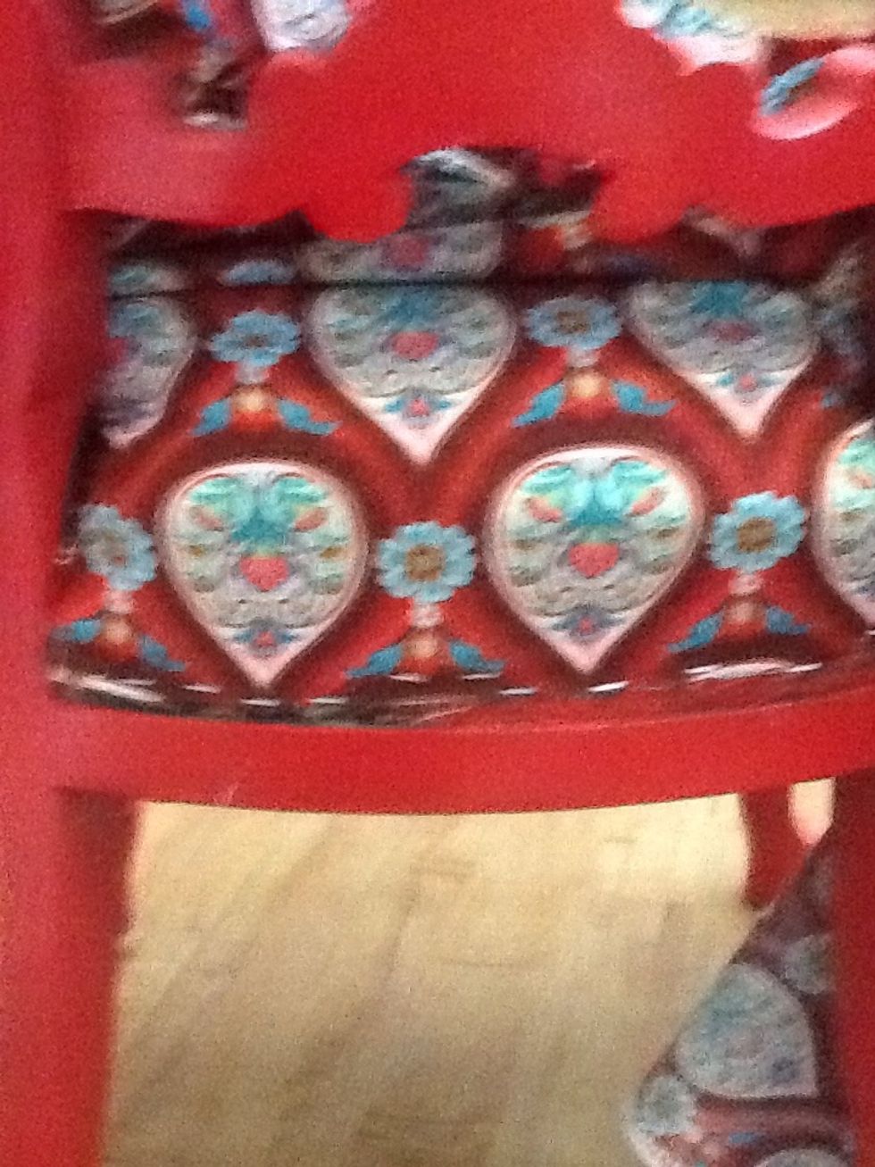 Cut your fabric about an inch bigger than your going to need it to be. Fold the edges in and staple them the to frame of the chair. Try getting as close to the frame as possible.