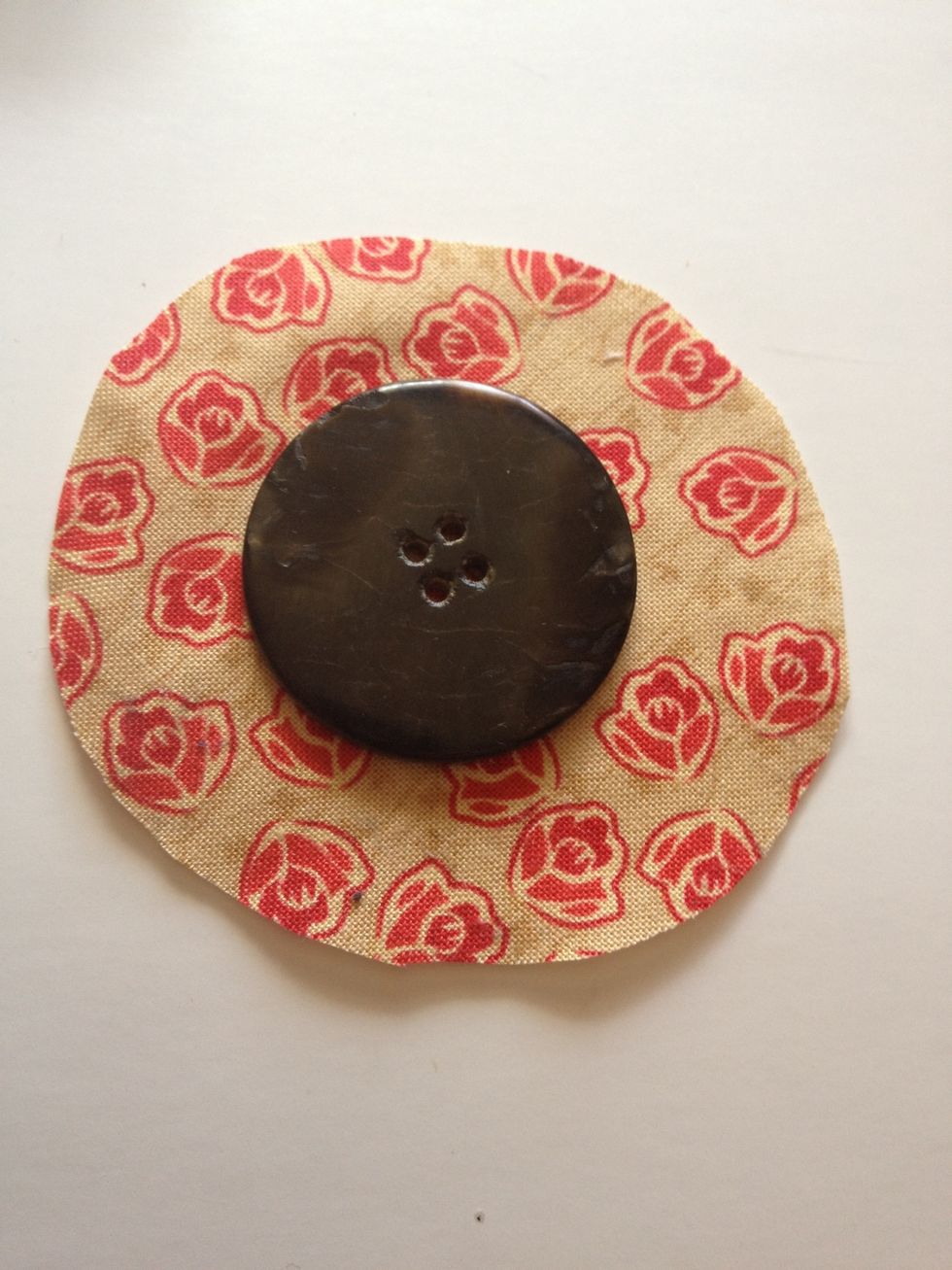 Cut your fabric scrap around your button, leaving about 1/2" to 3/4" excess around the outside (it does not need to be perfect, as you can see!)