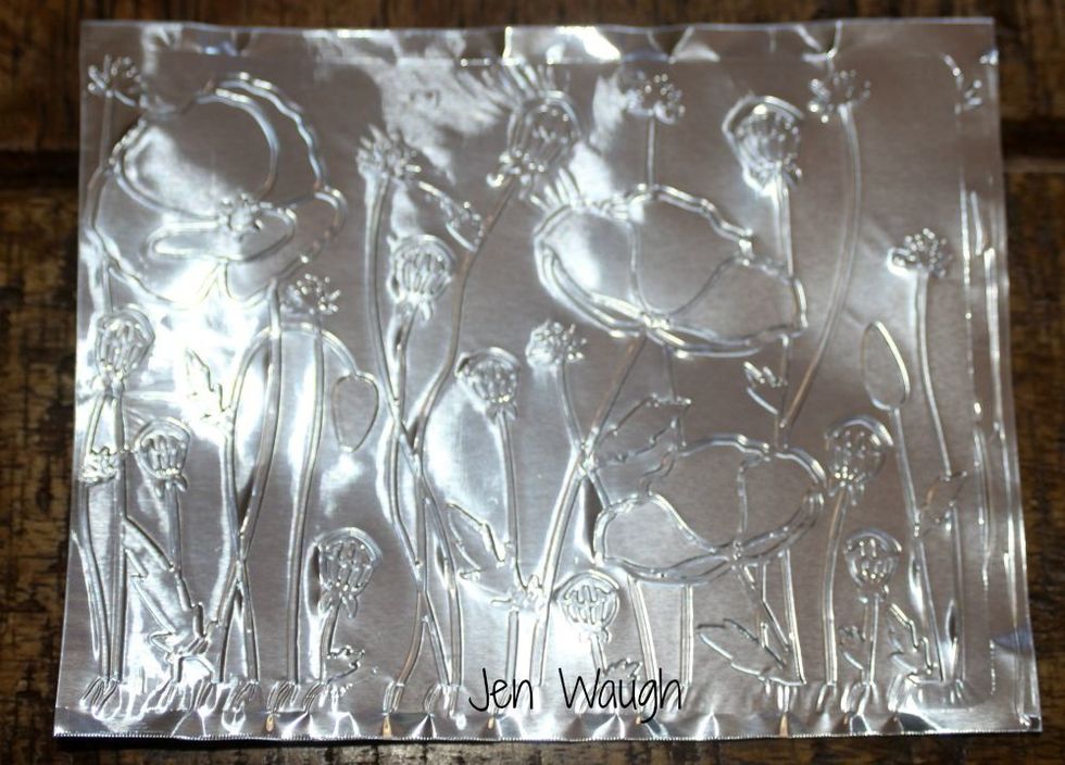 Cut your foil sheet to size and place it in your embossing folder. I then ran it through my Big Shot.