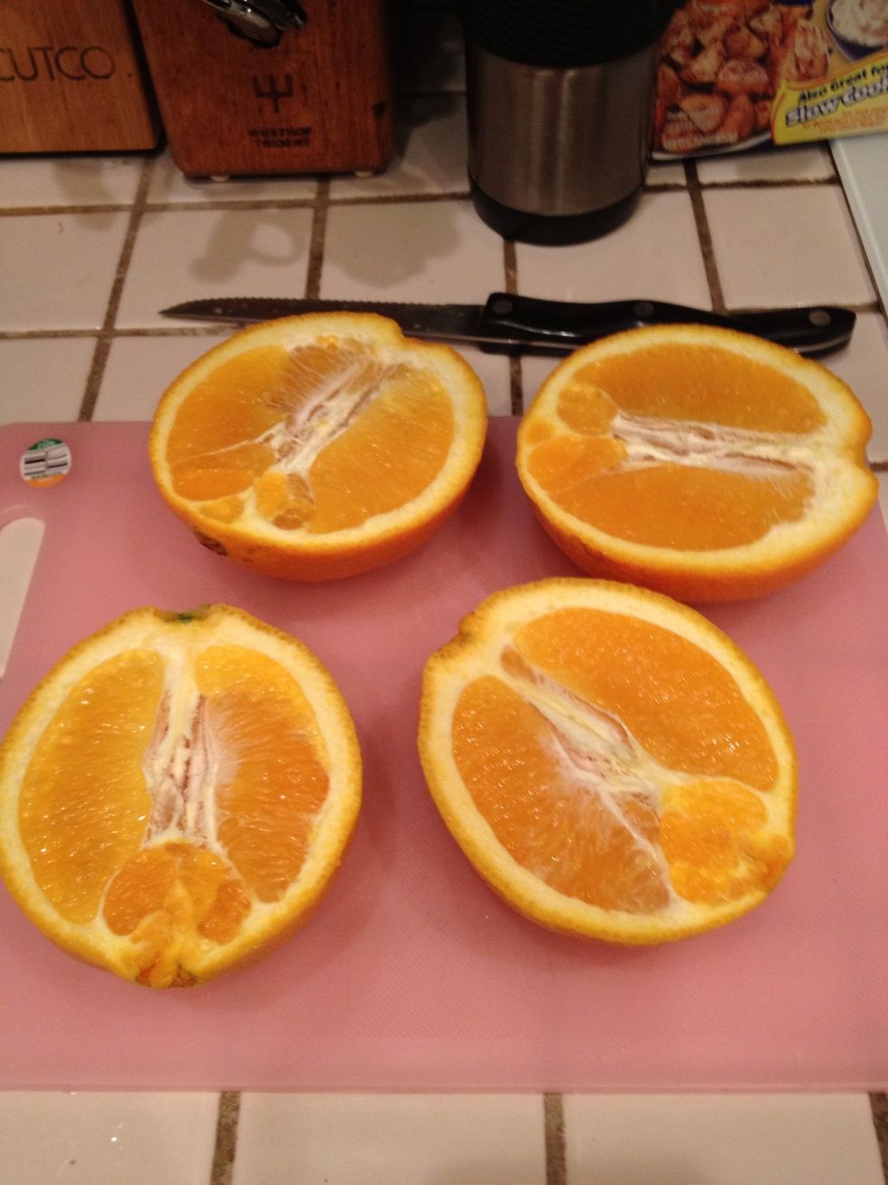 Cut your oranges in half.
