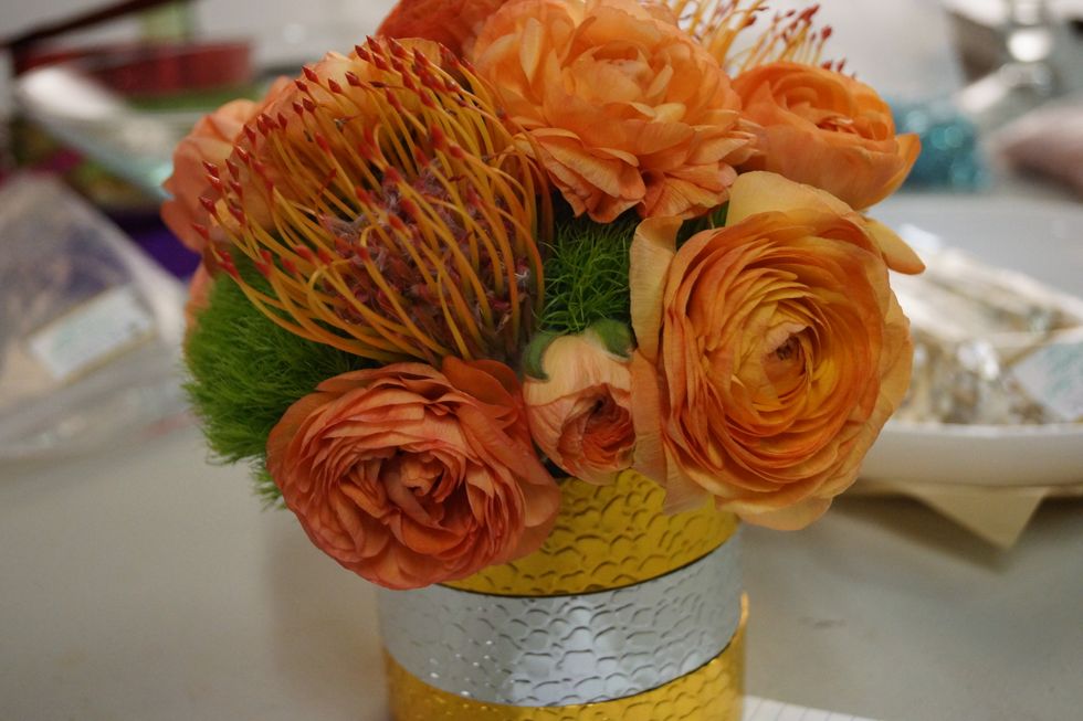 Cut your stems short to keep the design compact. Arrange flowers as desired. We've chosen to keep this design fairly monochromatic with a bold punch of orange!