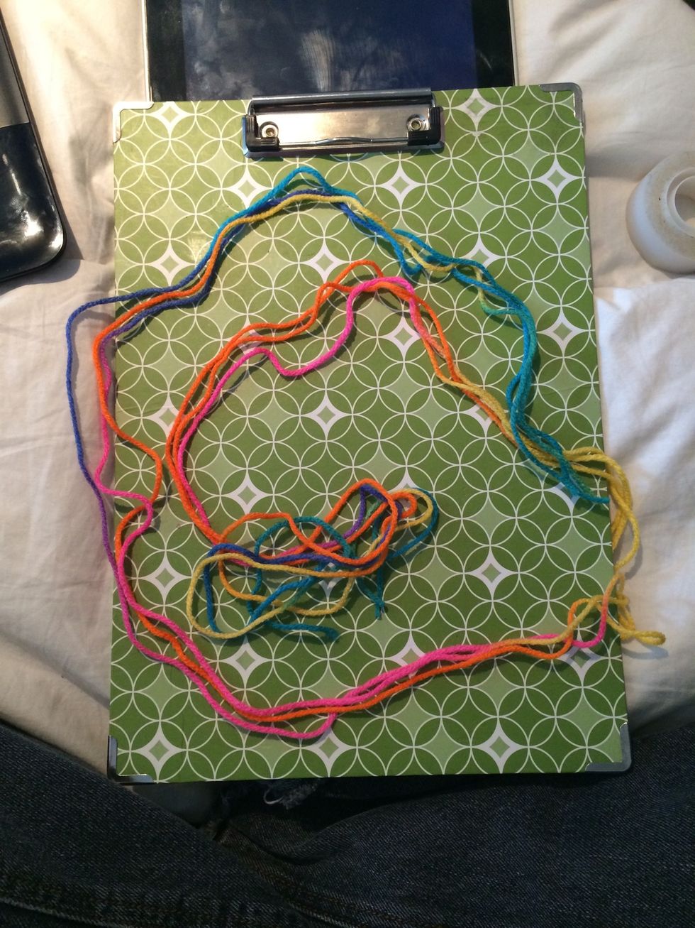 Cut your string or yarn. I use at least my entire arm spam in length.