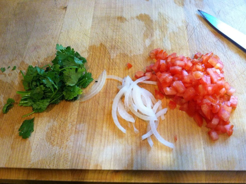 Cut your tomatoes and piece of onion. Wash your cilantro, if u don't like the taste of cilantro u can skip it
