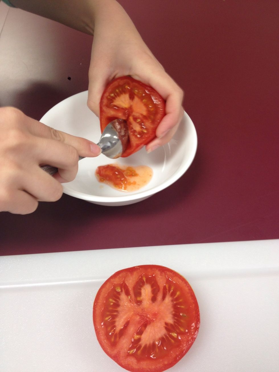 Cut your tomatoes in half crosswise, and reserve seeds and juice in a small bowl