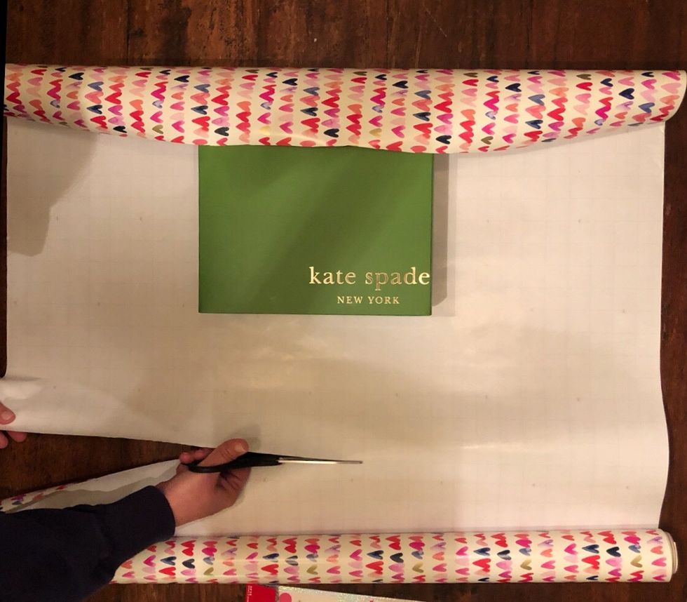 Cut your wrapping paper to the place that you measured in the previous step.