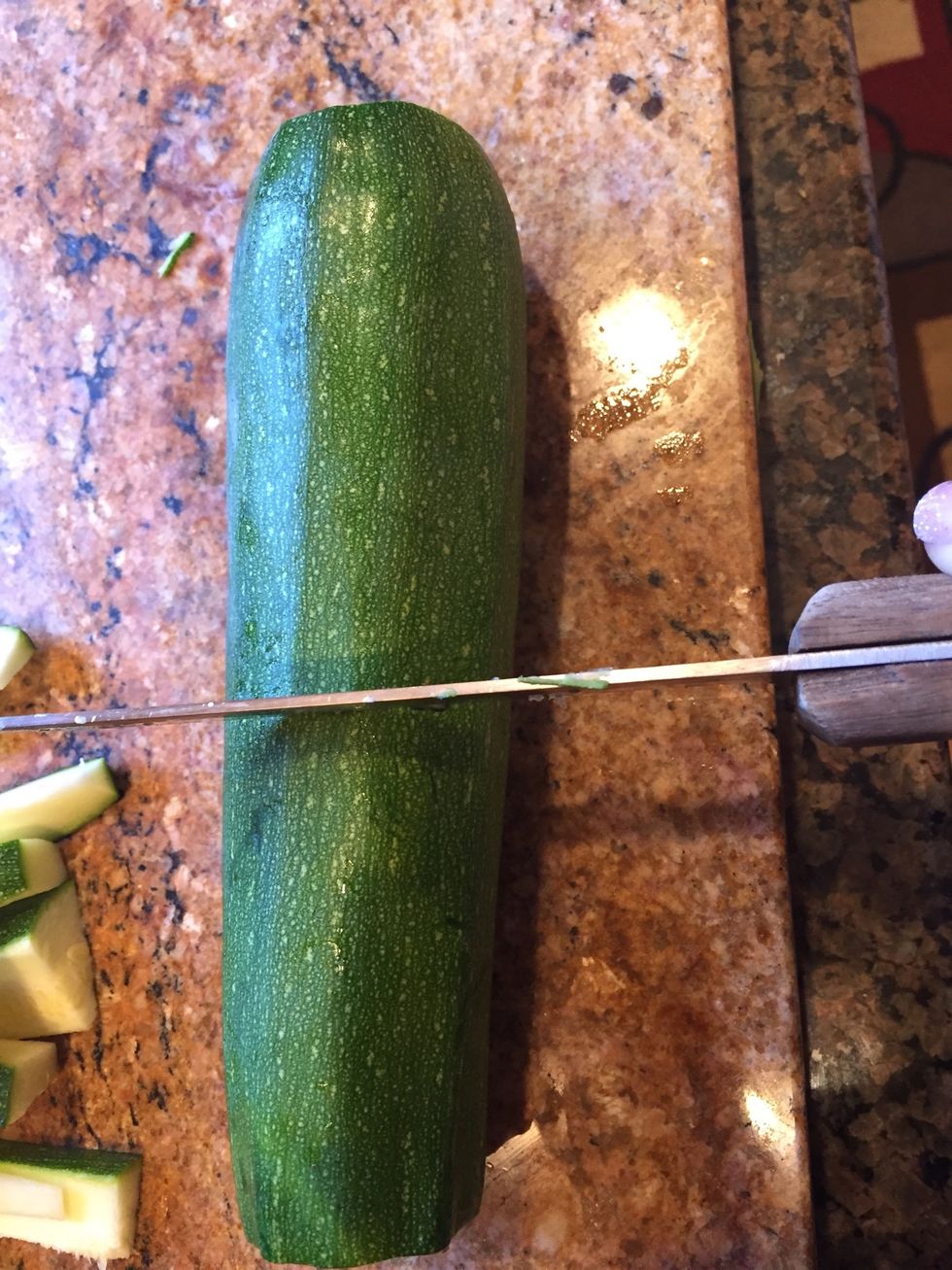 Cut zucchini in half.