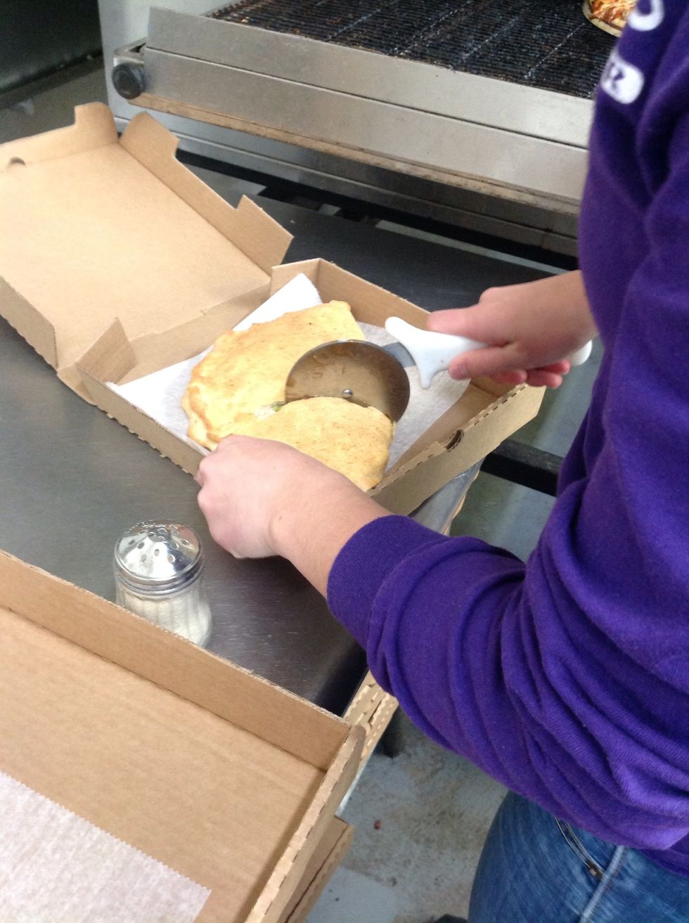 Cutting the calzone into 3 triangular pieces