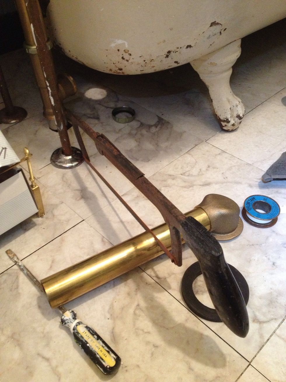 Cutting the main drain line to fit. NOT the best way to do it. I have a pipe cutter, but it wasn't big enough for this line.